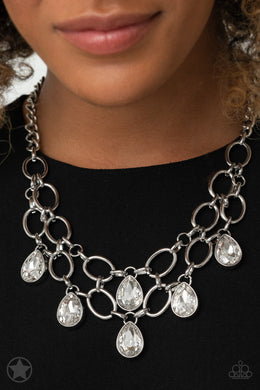 Joined by dainty silver links, two rows of dramatic silver chain layer below the collar in a fierce fashion. Glittery white teardrops drip from the glistening layers, adding a timeless shimmer to the show-stopping piece. Features an adjustable clasp closure.  Sold as one individual necklace. Includes one pair of matching earrings.