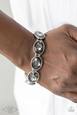 Smoky gems are pressed into sleek silver frames. Infused with dainty silver beads, the glittery frames are threaded along stretchy elastic bands for a glamorous look around the wrist.  Sold as one individual bracelet.