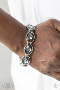 Smoky gems are pressed into sleek silver frames. Infused with dainty silver beads, the glittery frames are threaded along stretchy elastic bands for a glamorous look around the wrist.  Sold as one individual bracelet.