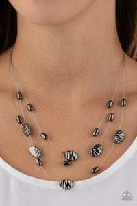 Featuring smooth and delicately hammered finishes, mismatched gunmetal beads are threaded along dainty silver wires, creating floating layers below the collar. Features an adjustable clasp closure.  Sold as one individual necklace. Includes one pair of matching earrings.