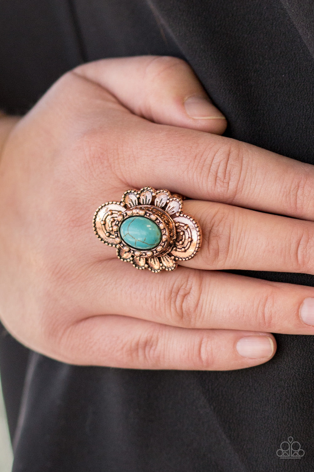 Dotted in shimmery patterns, textured copper petals bloom from a refreshing turquoise stone center for a bold seasonal look. Features a stretchy band for a flexible fit.  Sold as one individual ring.