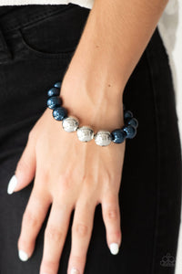 Gradually increased in size near the center, oversized pearly blue and shiny silver beads are threaded along a stretchy band around the wrist for a glamorous finish.  Sold as one individual bracelet.