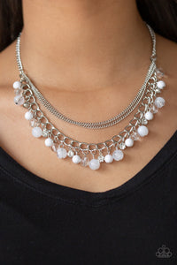 Infused with layers of mismatched silver chains, glassy, polished white, and glittery white rhinestones swing from the bottom of a bold silver chain, creating a bubbly fringe below the collar. Features an adjustable clasp closure.  Sold as one individual necklace. Includes one pair of matching earrings.