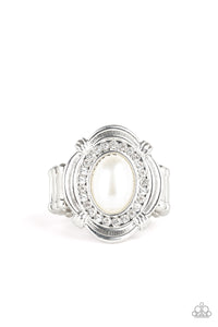 A pearly white bead is pressed into an ornate silver frame radiating with a ring of glassy white rhinestones, creating a timeless centerpiece atop the finger. Features a stretchy band for a flexible fit.  Sold as one individual ring.