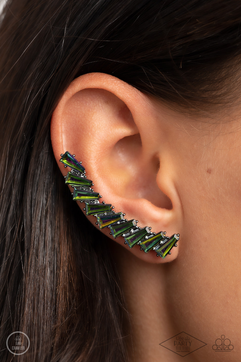 An icy stack of oil spill rhinestone gems climb the ear, coalescing into a shockingly sparkly frame. Earring attaches to a standard post fitting. Features a dainty cuff attached to the top for a secure fit.  Sold as one pair of ear climbers.
