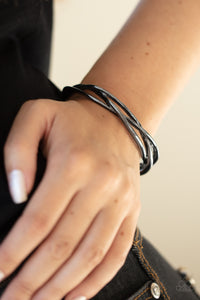 Glistening gunmetal bars braid across the wrist, creating a boldly plaited cuff.  Sold as one individual bracelet.