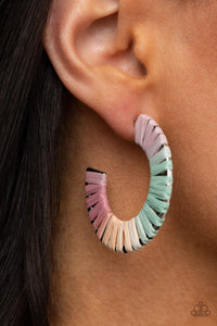Multicolored wicker-like cording wraps around a thick silver hoop, creating a flirty pop of color. Earring attaches to a standard post fitting. Hoop measures approximately 1 1/2" in diameter.  Sold as one pair of hoop earrings.