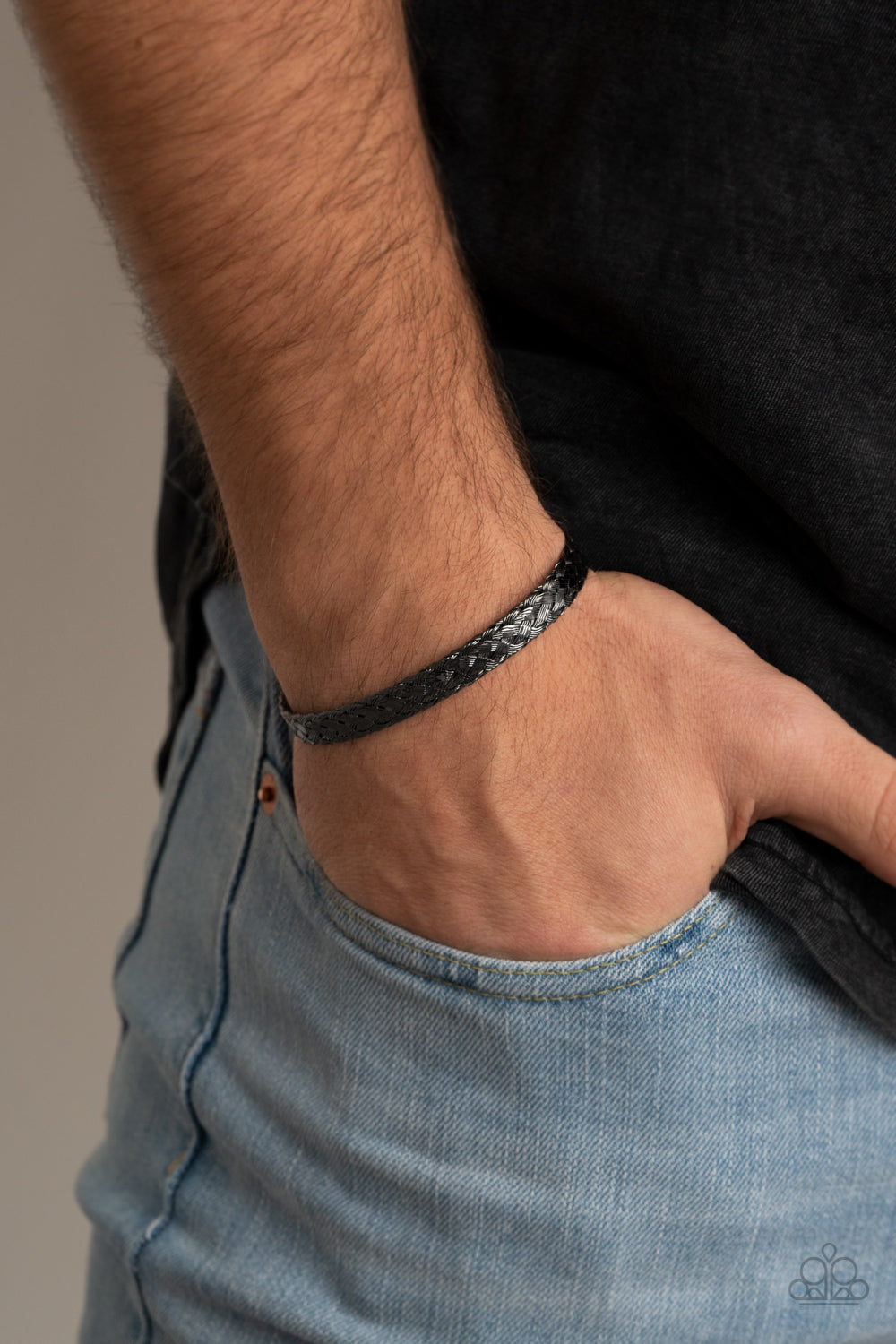 Featuring flattened sections, glistening gunmetal wires tightly weave into a dainty cuff for an edgy look around the wrist.  Sold as one individual bracelet.