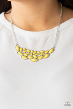 Load image into Gallery viewer, Encased in sleek silver frames, a collection of marquise shaped yellow beads delicately coalesce into a leafy pendant below the collar for a whimsical pop of color. Features an adjustable clasp closure.  Sold as one individual necklace. Includes one pair of matching earrings.