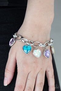 Multicolored heart-shaped gems are encased in sleek silver frames that swing from an oversized silver chain, creating a sparkly fringe around the wrist. Features an adjustable clasp closure.  Sold as one individual bracelet.