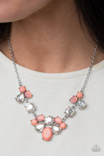Load image into Gallery viewer, Varying in opacity and shape, mismatched Burnt Coral beads attach to oversized white rhinestones, creating bubbly frames that delicately link into an ethereal display below the collar. Features an adjustable clasp closure.  Sold as one individual necklace. Includes one pair of matching earrings.