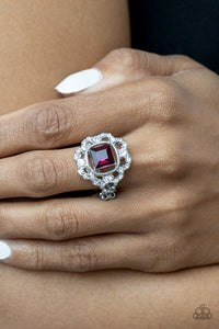 An airy flower-petal frame encrusted with brilliant white rhinestones highlights a stunning square-cut pink gem. Set in silver pronged fittings the timeless gem sits center stage creating a charismatic display atop the finger. Features a dainty stretchy band for a flexible fit.  Sold as one individual ring.
