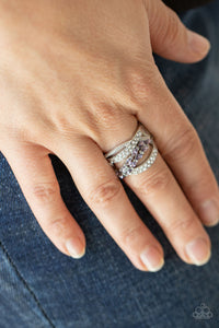 Mismatched bands of dainty silver studs, glassy white rhinestones, and marquise cut purple rhinestones delicately weave across the finger, creating an elegantly layered centerpiece. Features a stretchy band for a flexible fit.  Sold as one individual ring.