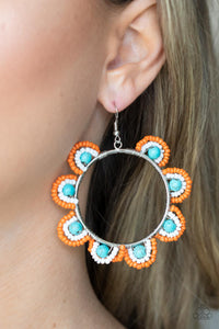 Infused with refreshing turquoise stone bead centers, rows of orange and white seed beads are threaded along dainty wires along the outside of a shiny silver hoop for a vivacious floral look. Earring attaches to a standard fishhook fitting.  Sold as one pair of earrings.