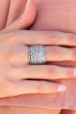 Brimming from edge to edge with a studded texture reminiscent of cobblestone, a wide silver band is bordered in dainty studs resulting in a free-spirited fashion atop the finger. Features a stretchy band for a flexible fit.  Sold as one individual ring.