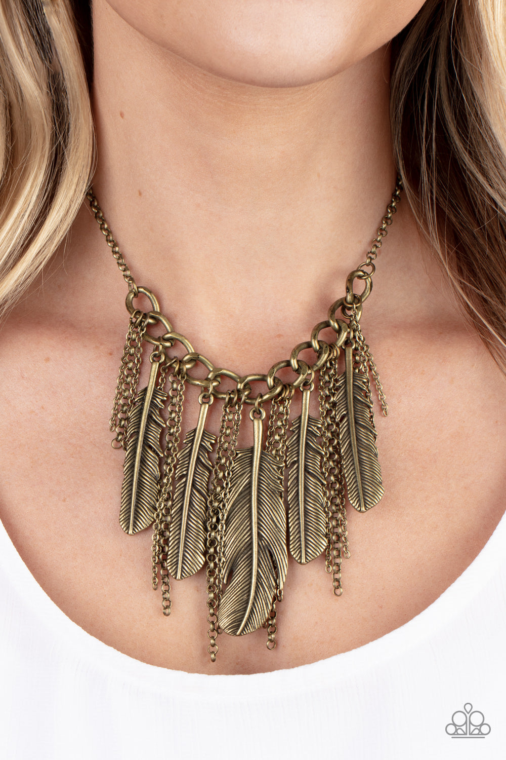 Infused with lifelike textures, an oversized assortment of brass feathers alternate with free-falling brass chains along a chunky section of brass chain, creating a free-spirited fringe. Features an adjustable clasp closure.  Sold as one individual necklace. Includes one pair of matching earrings.