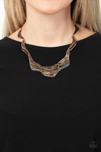 Featuring a rustic hammered finish, boomerang shaped silver, brass, and copper plates delicately link into artisan-inspired layers below the collar. Features an adjustable clasp closure.  Sold as one individual necklace. Includes one pair of matching earrings.
