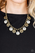 Load image into Gallery viewer, A blinding collection of hammered brass discs and oversized white gems swing from the bottom of a bold brass chain, creating noise-making sparkle below the collar. Features an adjustable clasp closure.  Sold as one individual necklace. Includes one pair of matching earrings.