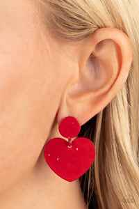 Painted in a glossy red finish, a hammered disc gives way to a hammered heart frame for a flirtatious fashion. Earring attaches to a standard post fitting.  Sold as one pair of post earrings.