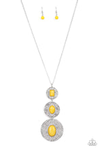 Load image into Gallery viewer, Mismatched emerald and oval cut mustard yellow acrylic beads adorn the centers of scratched silver discs that gradually increase in size as they link at the bottom of a lengthened silver chain. The beads vary in faceted and smooth finishes, adding a trendy finish to the colorful talisman-like pendant. Features an adjustable clasp closure.  Sold as one individual necklace. Includes one pair of matching earrings.
