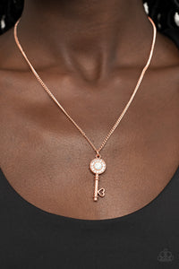 Bordered in glassy white rhinestones, an opal white rhinestone adorns a shiny copper key pendant at the bottom of a dainty shiny copper chain for a whimsical fashion. Features an adjustable clasp closure.  Sold as one individual necklace. Includes one pair of matching earrings.  New Kit